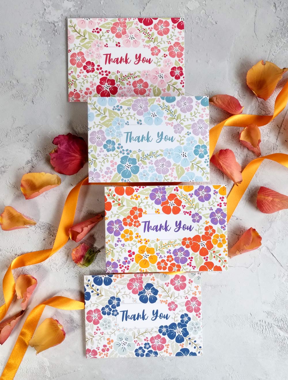 A set of four multi-colored floral thank you cards with recycled envelopes