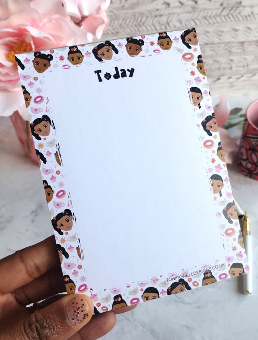 A6 Notepad with cute faces design and 'Today' text, held by a hand.
