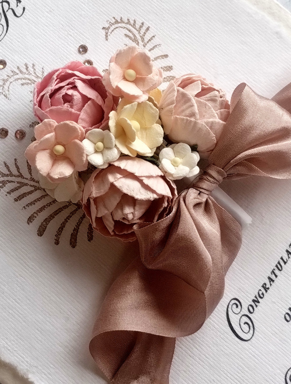 Close up of Handmade Pink A5 Wedding card with floral design.