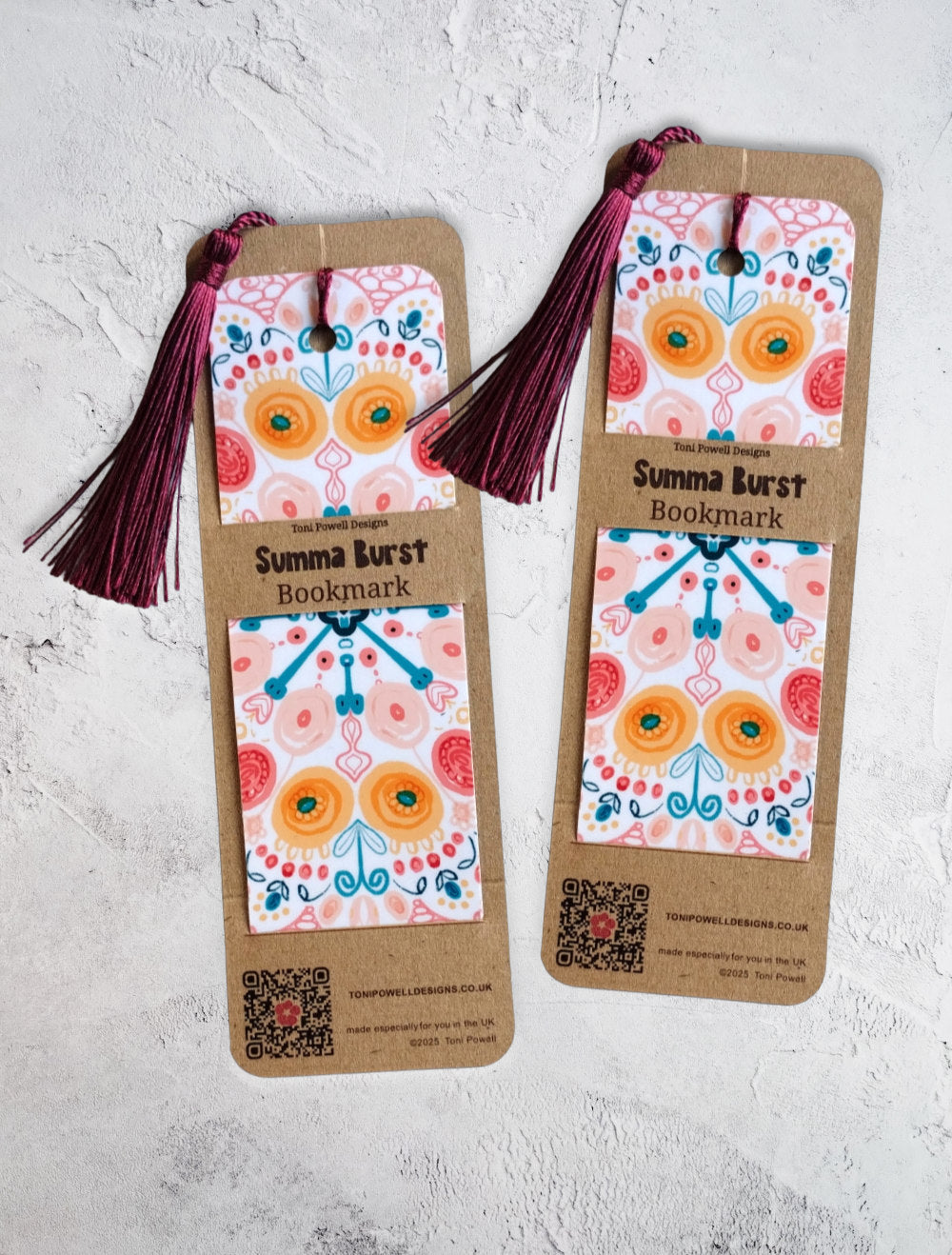 Summa Burst brightly patterned set of two bookmarks, embellished with a beetroot red tassel, in packaging