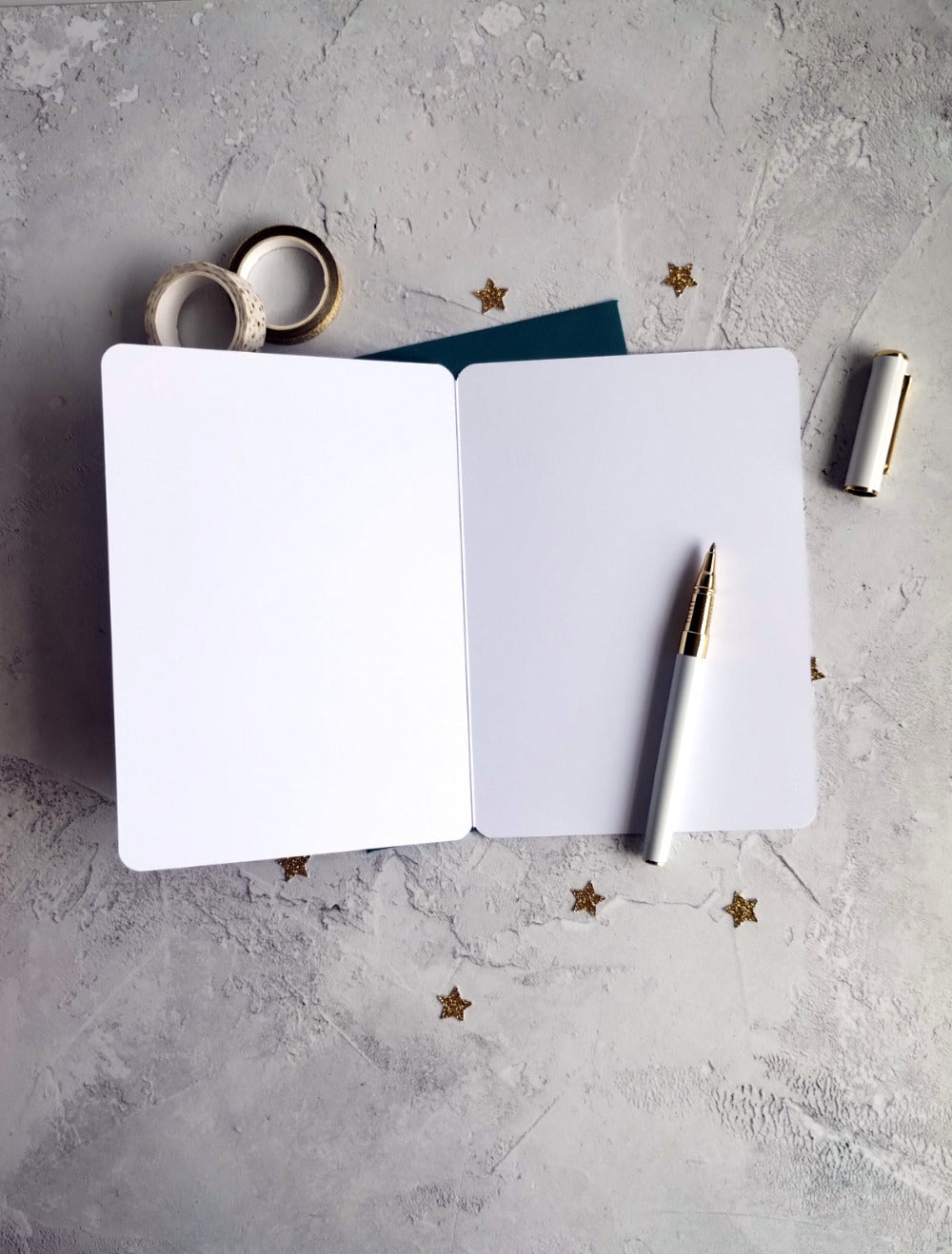 Open birthday card blank inside with a pen.