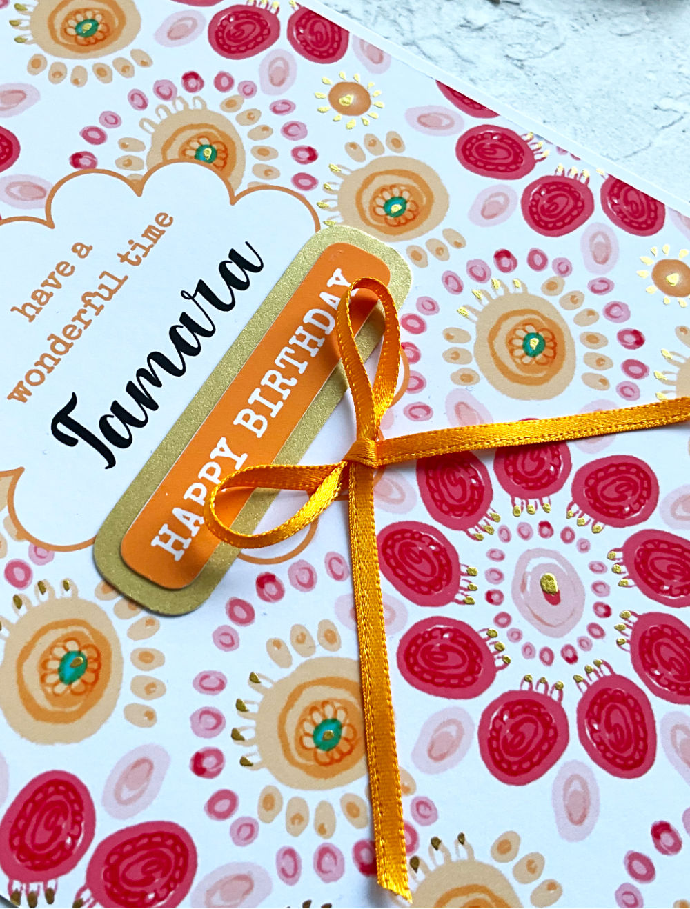 Summa Carnival Birthday card close up with colourful design finished with a golden yellow bow