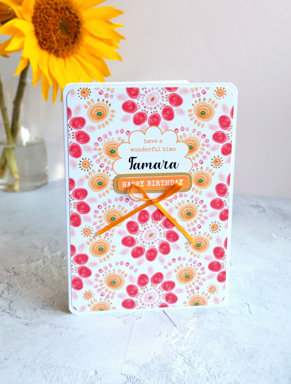 Summa Carnival Birthday card with colourful design finished with a golden yellow bow