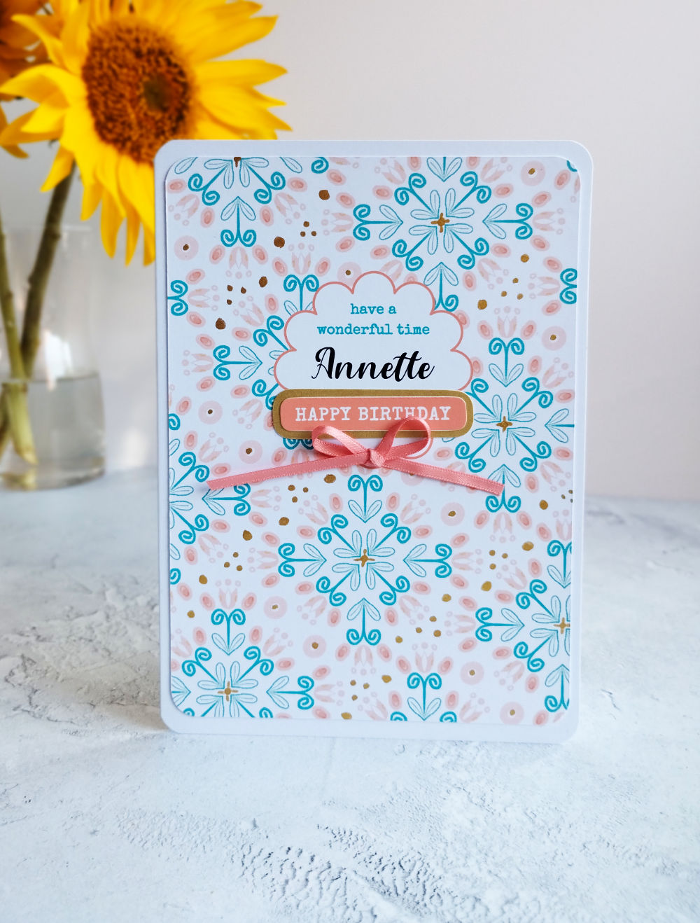 Personalised Birthday card with decorative patterns and a sunflower in the background.