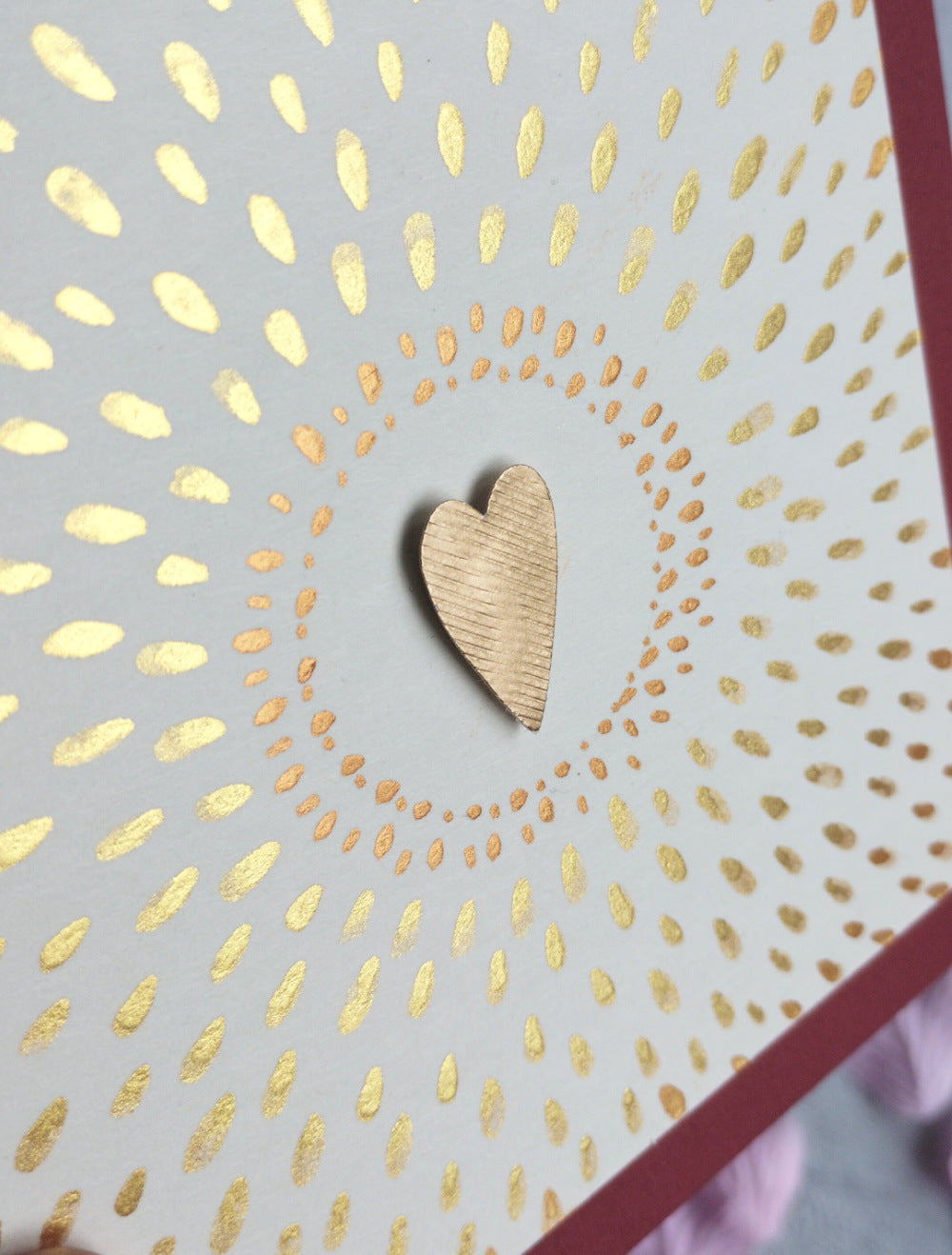 Love Shines Valentine's Card with gold heart design on a raspberry background with pink petals
