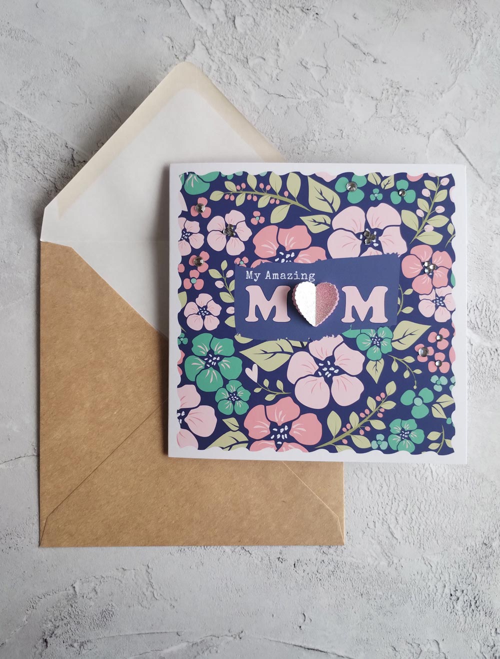 Bold floral Mother's day greeting card with a deep blue background and pink pop-out heart and recycled envelope