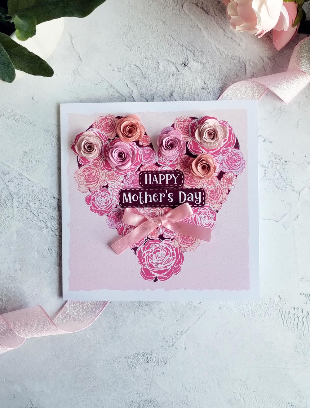 Pink Mother's day heart decorated with and-rolled paper flowers and hand-tied satin bow