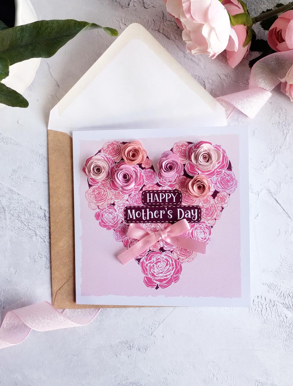 Pink Mother's day heart decorated with and-rolled paper flowers and hand-tied satin bow