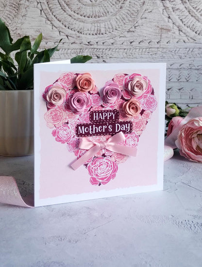 Pink Mother's day heart decorated with and-rolled paper flowers and hand-tied satin bow