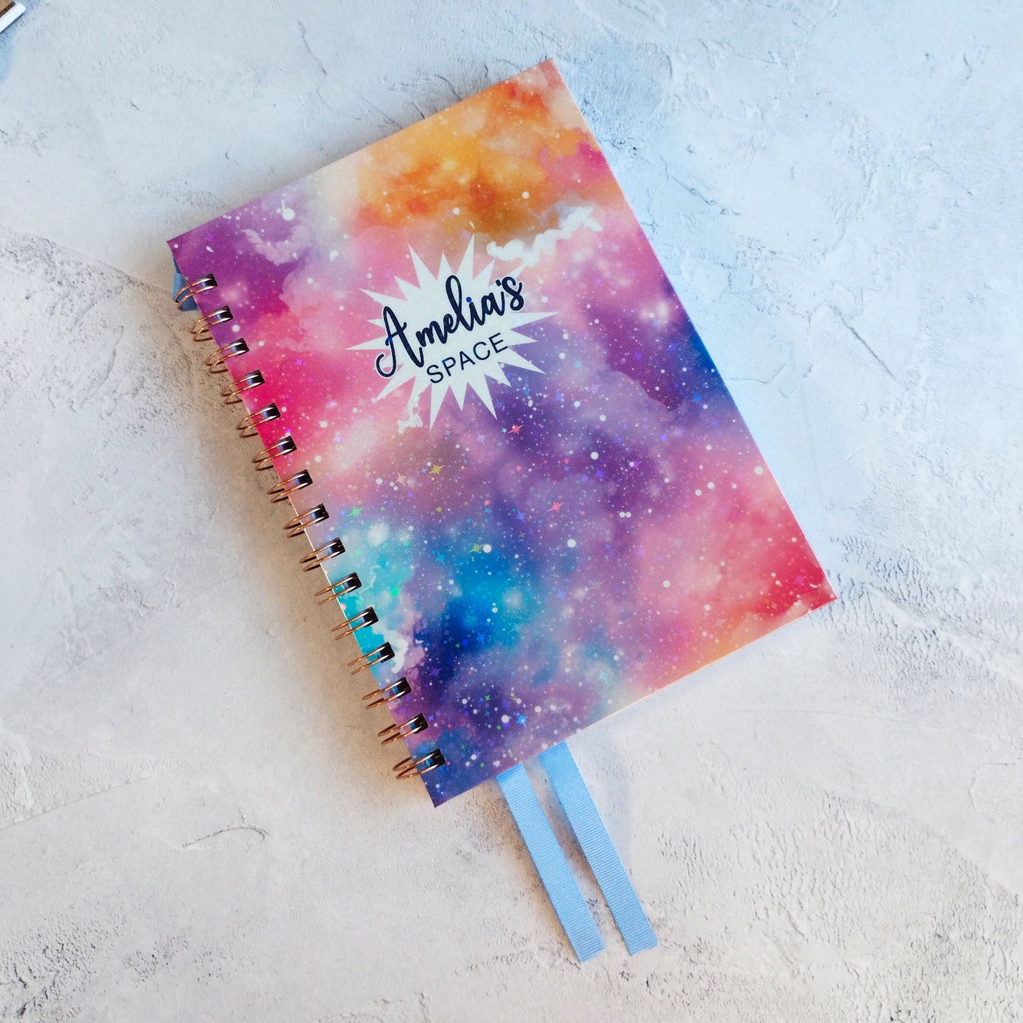 The  colourful Dream Space A5 notebook with blue grosgrain ribbon bookmarks