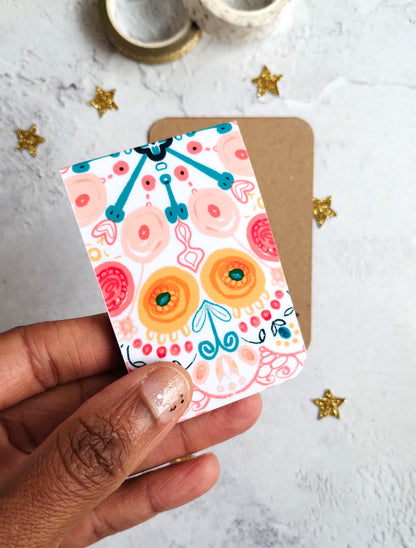 Hand holding Summa Burst Magnetic bookmark with bright colourful pattern design.