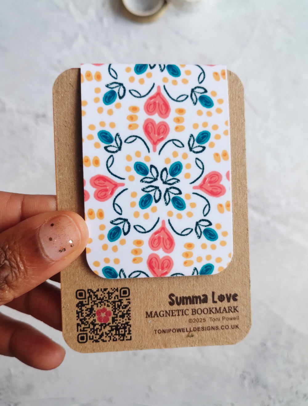 Summa Carnival Magnetic bookmark with bright heart pattern design held to show the size