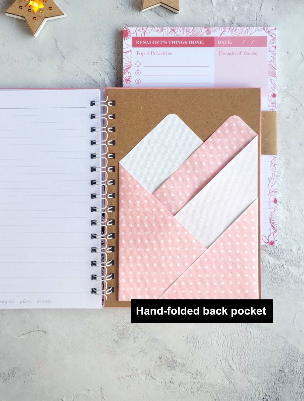 Notebook with a pink hand-folded back pocket 