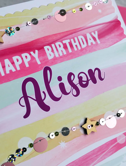 Happy Birthday card with colourful stripes and hand-sewn sequins on a white background