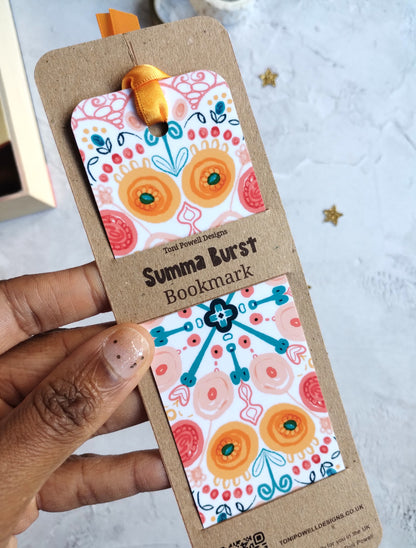 Close up of Summa Burst bookmark decorated with a sunset yellow ribbon in kraft recycled card packaging