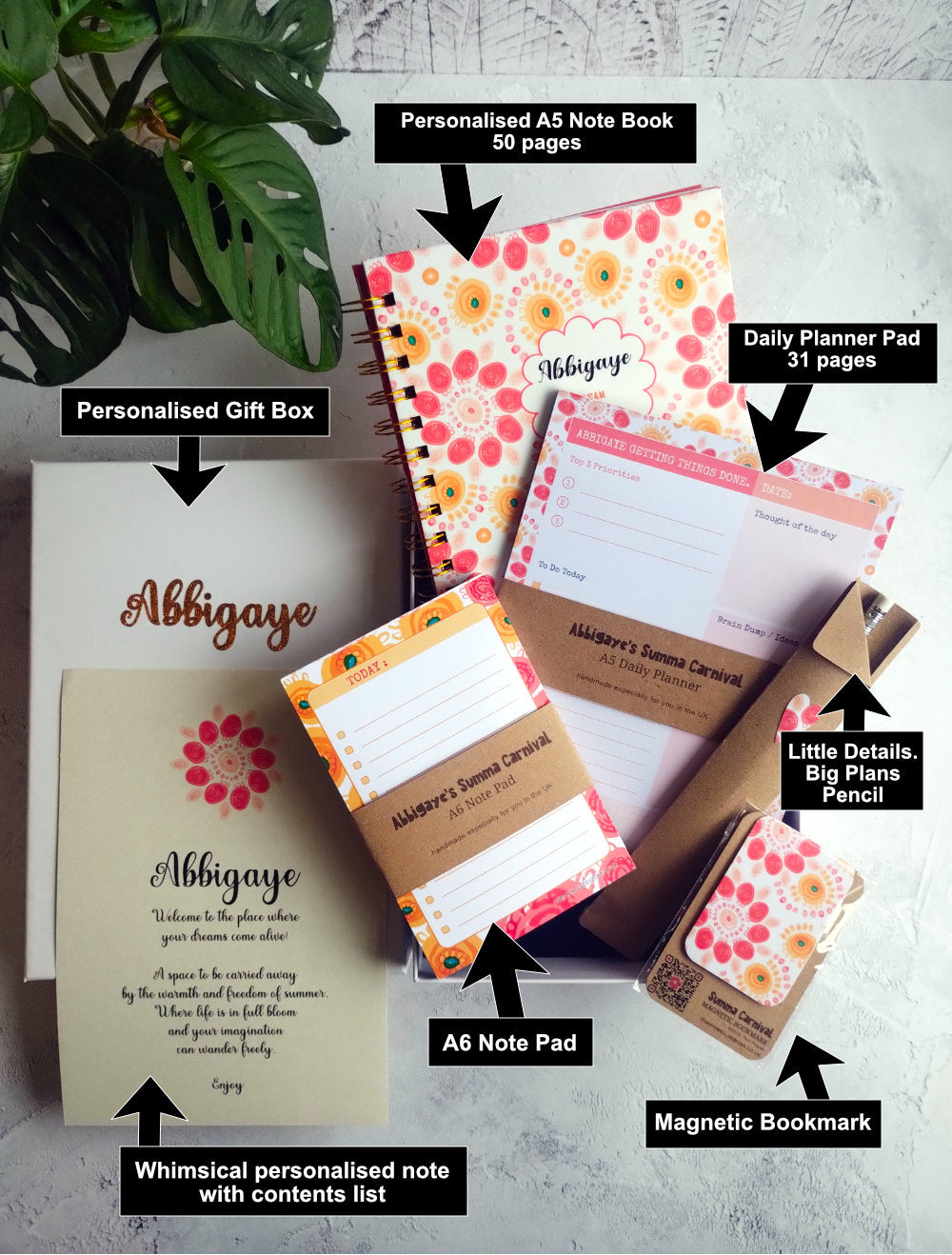 Colourful collection of handmade stationery items including notebook, planner pad, note pad, pencil, magnetic bookmark and a gift box.