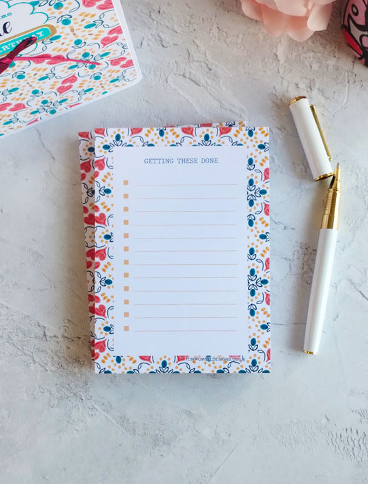 Stack of to-do list notepads with heart pattern decoration