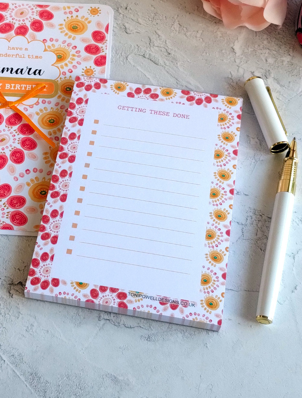 Bright pattern notepad with a pen on a light surface